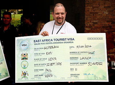 A tourist holds a dummy East African Tourist Visa during the launch in January.  File.