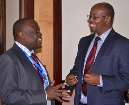 Local Government minister James Musoni (R) chats with ICGLR executive director Frank Okuthe at the governance meeting in Kigali yesterday. John Mbanda.