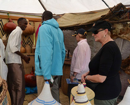 Roestenburg (2nd R) with colleagues receive information on Rwandan traditional materials. Jean Mbonyinshuti