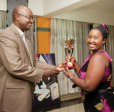 Uwamwezi receives her award from ICAR president Rugero Paulin for her contribution to the crafts sector recently. The food processing entrepreneur says planning and networking are key for one to grow a business. 
