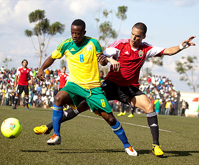 Amavubi skipper Haruna Niyonzima challenges Libya's defender in the first round of the qualifying campaign which Rwanda won 3-0. T. Kisambira
