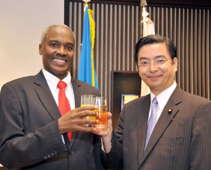 Amb. Murigande and Yamamoto toast during the event. Yodhiski Miura. 