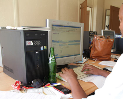 A worker busy in office. Many civil servants will be affected by the impending restructuring of the civil service. T.Kisambira.