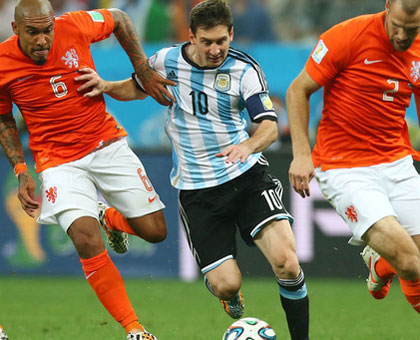 Argentina's Lionel Messi powers through Dutch defense in yesterday's semi final. Argentina set up a final clash against Germany. (Internet photo)