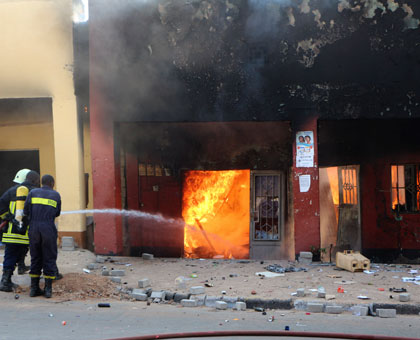Fire fighters contain the fire that razed businesses at Quartier Mateus last week. John Mbanda.