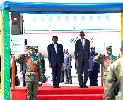 Presidents Paul Kagame and his visiting Equatorial Guinean counterpart Teodoro Obiang Nguema Mbasogo honour national anthems played to welcome the latter to the country at Kigali International Airport yesterday. Village Urugwiro.