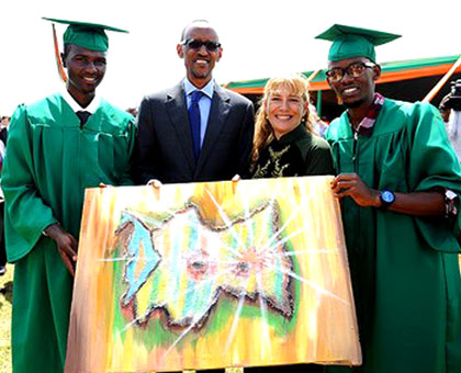 Nkunda (L) presents a painting to President Kagame during his graduation. The youth, who only learnt to speak English five years ago, has shaken off a yoke of misery to realise his dreams, mainly through his passionu2013art. Courtesy.