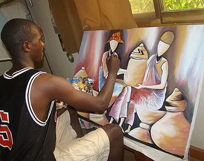 Emmanuel Nkundabankundiye puts final touches on one of his paintings. Courtesy. 
