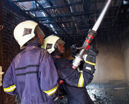 Firefighters put out the fire that razed property in a Nyabugogo business complex on Tuesday. (Timothy Kisambira)
