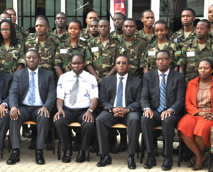 Government officials pose for a photo with the youth. (Stephen Rwembeho)