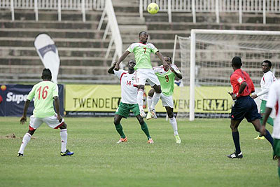 Burundians Rashid Harerimana (left) and Hussein Shaban (front) crowd out  Jockins Atudo from Kenya during their friendly match at Nyayo Stadium on July 15, 2014. 
