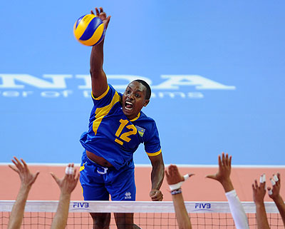 Rwandau2019s Aimable Mutuyimana spikes against Moroccou2019s triple block in the classification match at Menu2019s FIBA U21 World tournament.
