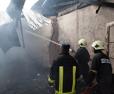 Police firefighters struggle to put out a fire. File.
