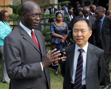 Labour minister Anastase Murekezi (L) chats with Korean Ambassador to Rwanda, Hwang Soon Taik, after the opening of the senior officialsu2019 workshop yesterday. John Mbanda. 