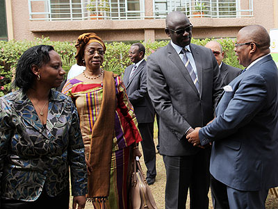 Justice minister Johnston Busingye (2R) greets Med Kaggwa, a Commissioner with African Commission for Human and Peopleu2019s Rights as President of the commission Sylvie Kayitesi (L), and President of the African Court of Human and Peoplesu2019 Rights Sophia Akuffo, look on last week. John Mbanda.