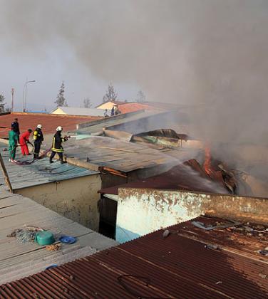 Police fire brigade personnel put out a fire in Kigali. Most Rwandan firms donu2019t insure their businesses / John Mbanda. Kisambira