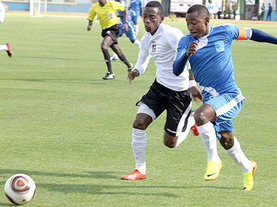 Rayon Sport's skipper Fuadi Ndayisenga attempts to dribble past APR's Michel Rusheshangoga. The two rival sides will take part in the two-week long regional tournament. Courtesy