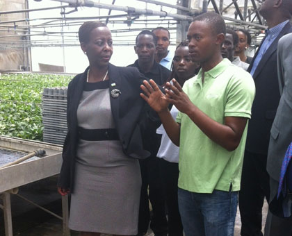 One of the Rwandan students demonstrates to Minister Mushikiwabo during her meeting with Rwandans studying agriculture in Israel. (Courtesy)