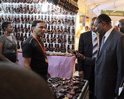 Trade and Industry Minister Francois Kanimba (R) with BNR Governor John Rwangombwa look at shoes on one of the stands at the Expo yesterday. John Mbanda