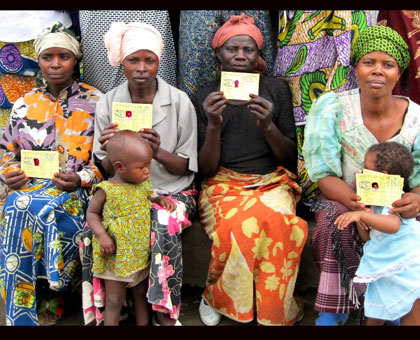 Mothers display their Mutuelle de Sante cards. Experts attribute Rwandau2019s performance to provision of health care to all citizens. File. 