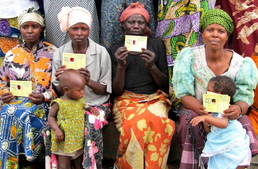 Mothers display their Mutuelle de Sante cards. Experts attribute Rwandau00e2u20acu2122s performance to provision of health care to all citizens. (File) 