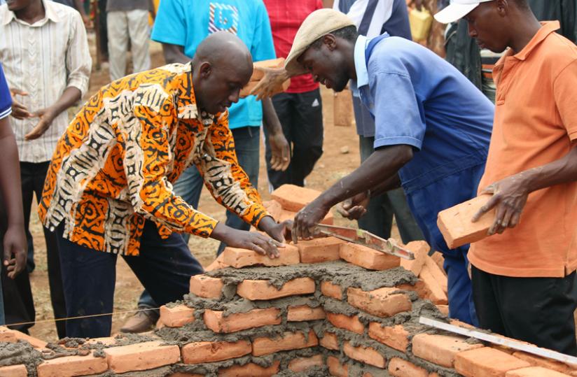 Minister Francis Kaboneka participates in Umuganda to build houses for Rwandans evicted from Tanzania at Jabana. (Clu00c3u00a9ment Uwilingiyimana)