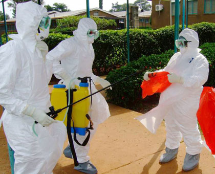 World Health Organisation officials prepare to enter Kagadi Hospital in Kibaale District, Uganda, where an outbreak of the Ebola virus started in July 2012. Net photo. 