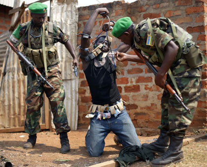  Rwandan peacekeepers in Central African Republic disarm a militiaman earlier this year. Courtesy.