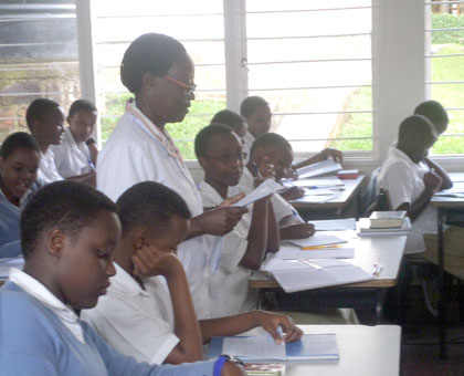Mukaritamu reads notes to students while top right, Mukaritamu uses her laptop to do research. (Solomon Asaba)