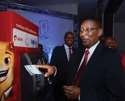 Central bank chief John Rwangombwa withdraws money from an I&M Bank ATM to launch an Airtel Money and I&M Bank partnership that enabled Airtel Money clients to withdraw cash from the banku2019s ATMs. (File)