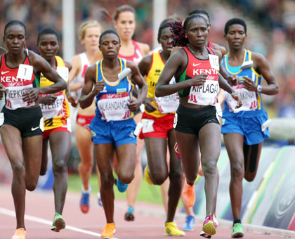 Clu00e9mentine Mukandanga (C) finished 10th to set a new personal best in 10,000m, while Claudette Mukasakindi (R) came in 11th position. (Courtesy)