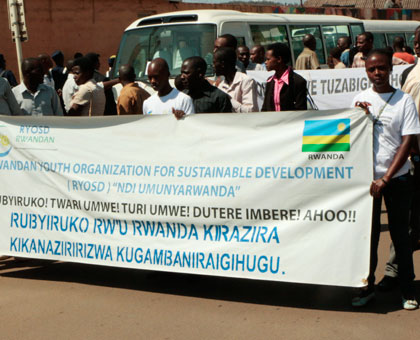 Youth hold a banner in preparation for the carnival walk in Nyamirambo, Kigali yesterday. (Plaisir Muzogeye)