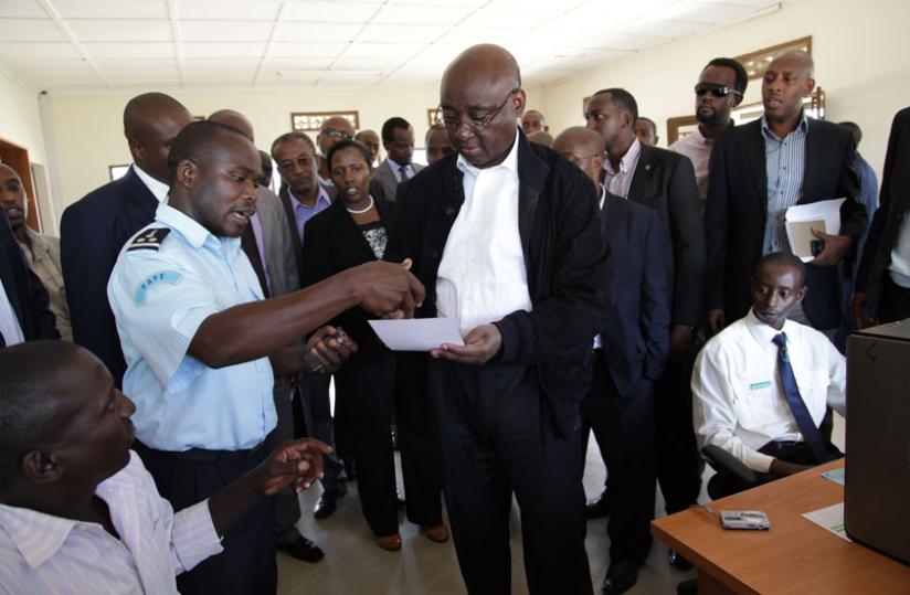 An Immigration Officer at Nemba Border post (L) chats with African Development Bank President Donald Kaberuka (R) in the recent past. (File) 