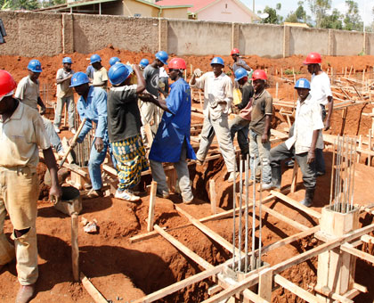 Workers on a construction site in Kicukiro District. There are efforts to increase minimum wage from the current Rwf 100 per day. File