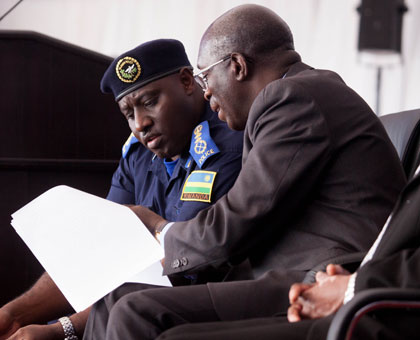 IGP Emmanuel K. Gasana compares notes with Prime Minister Anastase Murekezi  at the launch of the Police Book yesterday.   Timothy Kisambira.