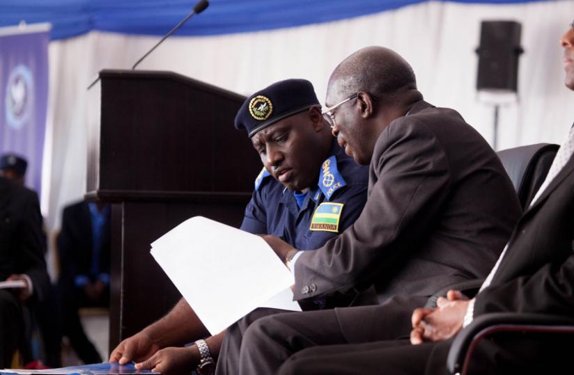 IGP Emmanuel K. Gasana compares notes with Prime Minister Anastase Murekezi at the launch of the Police Book yesterday. (Timothy Kisambira)