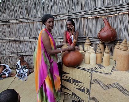 An elderly lady at the museum explains how milk is preserved. 
