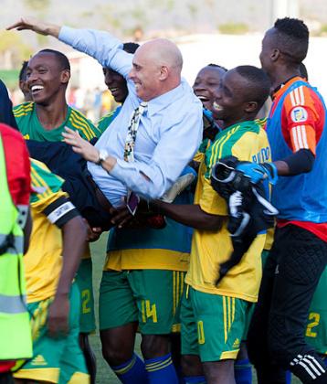 Head coach Stephen Constantine is lifted shoulder high by players after Rwanda defeated Congo on Saturday. T. Kisambira