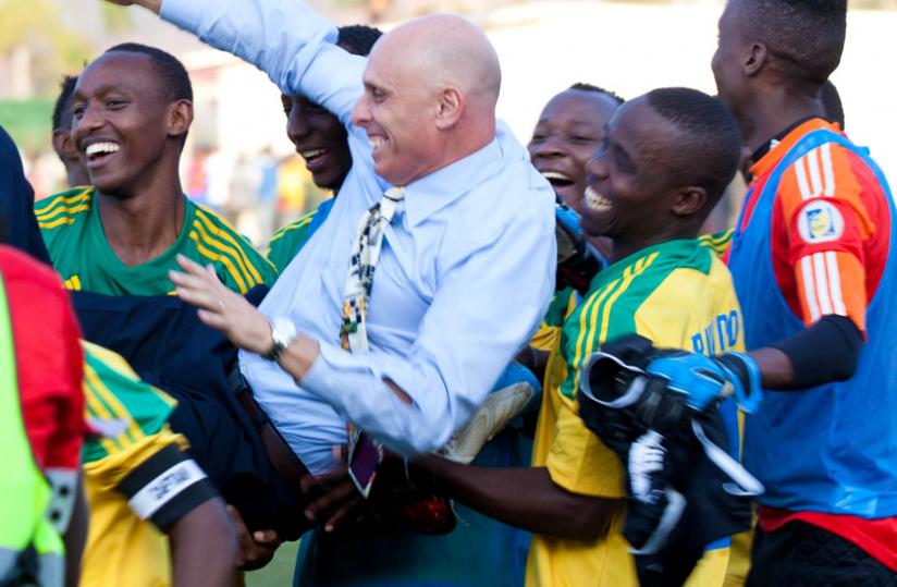 Head coach Stephen Constantine is lifted shoulder high by players after Rwanda defeated Congo on Saturday. (Timothy Kisambira)