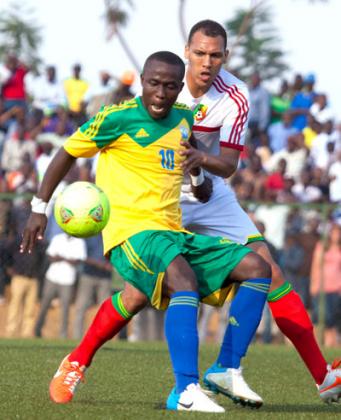 Amavubi striker Michel Ndahinduka shields the ball against a Congolese defender during the return leg match on Saturday. T. Kisambira