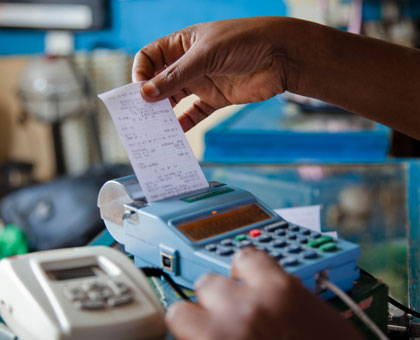 A trader pulls a receipt out of the electronic billing machine at Mateos in the recent past. File.