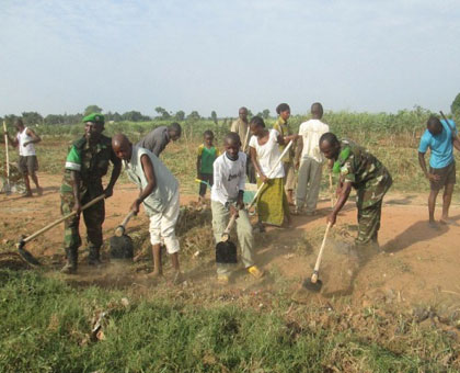 Rwandan peacekeepers are joined by Central African Republic residents at the launch of Umuganda (community service) in Bangui earlier this year. (File) 