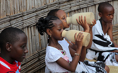 Children drink milk from traditional containers (Inkongoro) during the harvest day at the Kingu2019s Palace in Nyanza last week. John Mbanda. 