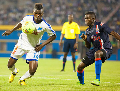 Rayon Sportu2019s midfielder Motombo Govin attempts to dribble past defender Mbaga Gadiel Michael of Azam yesterday at Amahoro stadium.  T. Kisambira