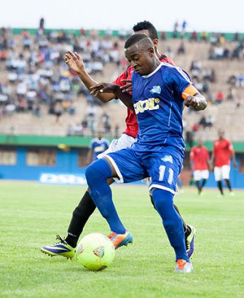 Rayon Sports captain Fuadi Ndayisaba shields the ball against an Adama City defender yesterday at Amahoro stadium. Ndayisaba was named Man of the Match. T. Kisambira.