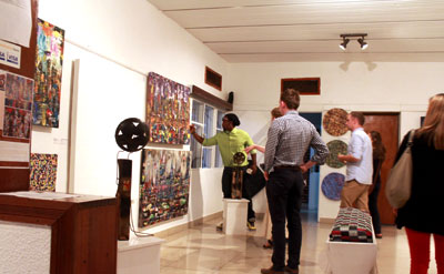 Visual artist Nkuranga shows revellers some of his art works on Saturday.