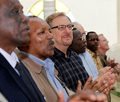 Pastor Rick Warren in black stripped shirt with other clerics in Kigali last year.Timothy Kisambira. 