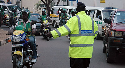 A traffic officer guides motorists in Kigali. New traffic penalties are envisaged to curtail accidents. File. 