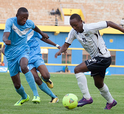 APR winger Jean Claude Iranzi (R), tries to go past an Atletico de Burundi defender during the first game in Group B on Saturday, which the Rwandan side won 1-0. T. Kisambira