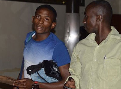 Nigerian striker Yunana Yanawo, left, and Rayon Sports team manager Thierry Hitimana on arrival at Kigali Internaional Airport. Courtesy